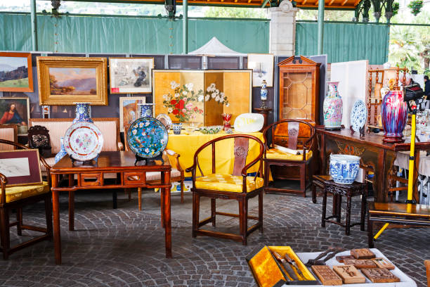 Furniture and paintings on sale at antiques market Montreux, Switzerland - May 25, 2013: Furniture, paintings and other stuff offered for sale during a cyclical event, which takes place in the famous Covered Market montreux photos stock pictures, royalty-free photos & images