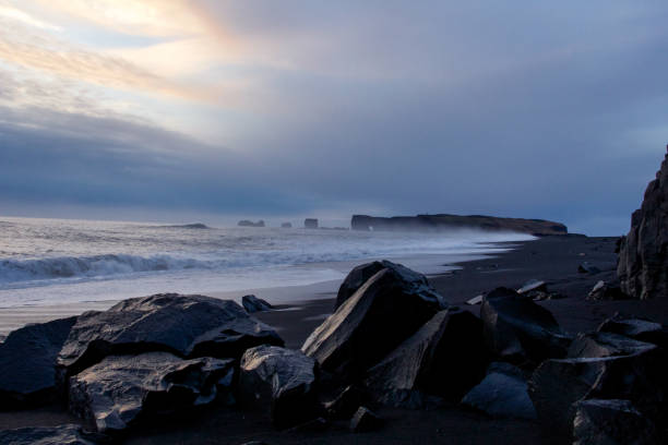 istock Black volcanic rocks at Reynisfjara beach and Cape Dirholaey, Iceland 645248966