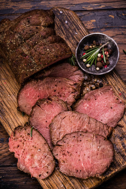 istock Roast beef on cutting board with salt and pepper. Top view. 645251552