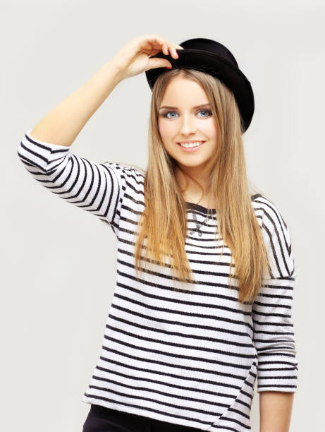 istock Beautiful girl laughing, wearing  a black hat 645255282