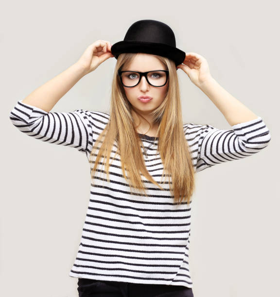 istock Beautiful girl laughing, wearing  a black hat 645255292
