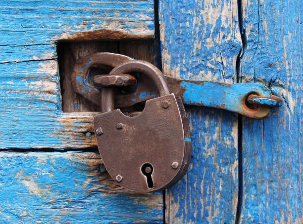 istock Rusty lock on a blue wooden door 645257786