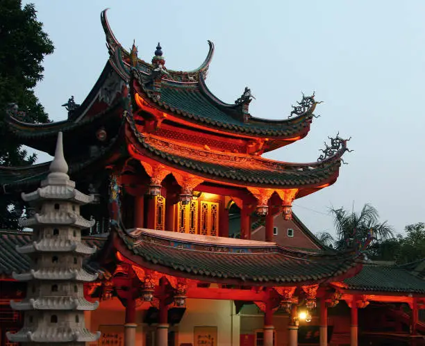 Photo of XIAMEN, FUJIAN PROVINCE, CHINA - OCT 30, 2009: Night view of South Putuo Temple (Nanputuo), famous Buddhist temple founded in Tang Dynasty, Xiamen, Fujian province, China