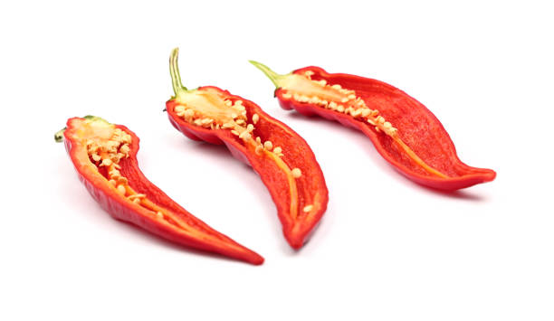 istock Three cut hot chili peppers isolated on white 645258212