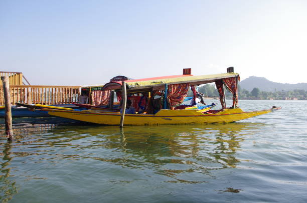 Shikara on the Nagin lake in Srinagar in Kashmir, India Local people use small boats called shikara to transport tourists on the Nagin lake in Srinagar in Kashmir, India lake nagin stock pictures, royalty-free photos & images