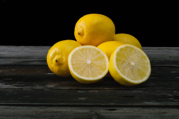 istock Fresh lemons on an old wooden table. 645276656