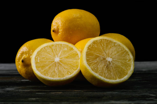 istock Fresh lemons on an old wooden table. 645276716