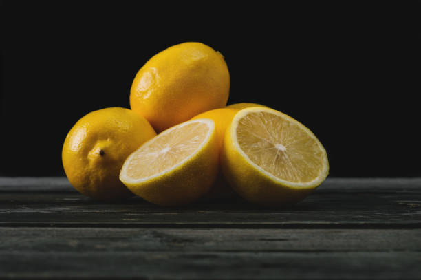 istock Fresh lemons on an old wooden table. 645276722