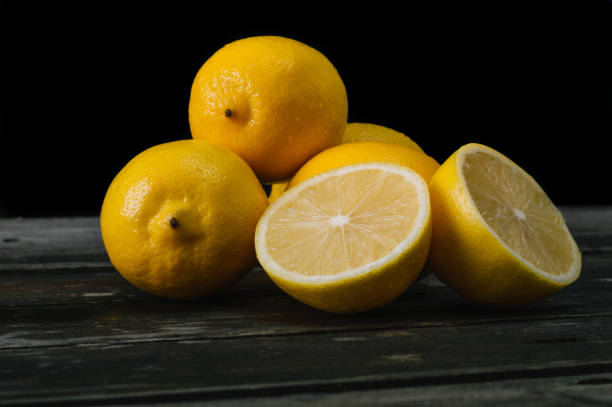istock Fresh lemons on an old wooden table. 645276728