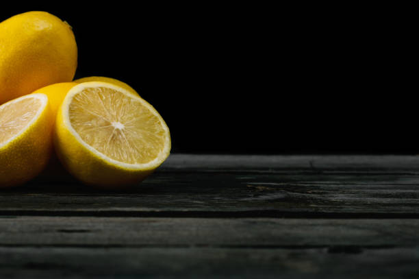 istock Fresh lemons on an old wooden table. 645276730