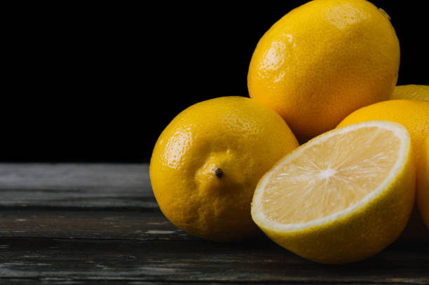 istock Fresh lemons on an old wooden table. 645276780