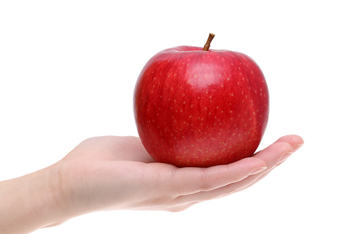 Red apple on the hand