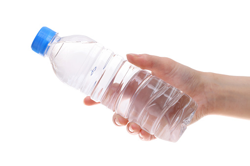 Hand holding bottle of water isolated on white background