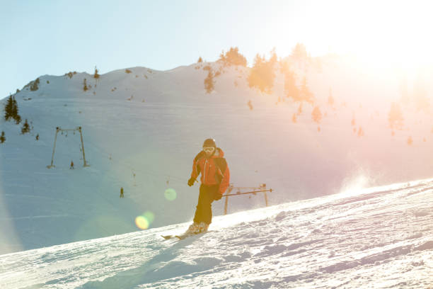 istock Skier skiing downhill in high mountains against sunset 645289688