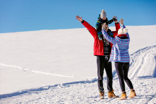 istock Attractive family having fun in a winter park on mountain 645289868
