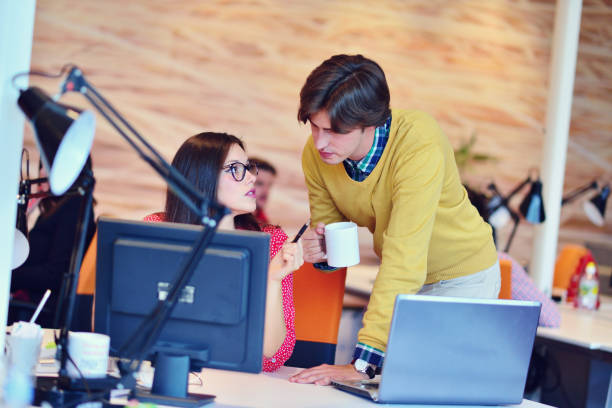 istock business couple working together on project at modern startup office 645292270