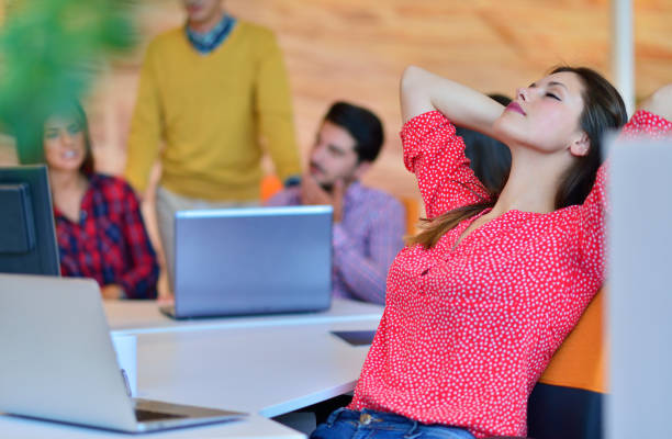 istock Business woman relaxing with her hands behind her head 645292898