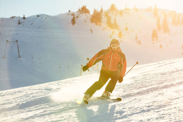 istock Skier skiing downhill in high mountains against sunset 645293260