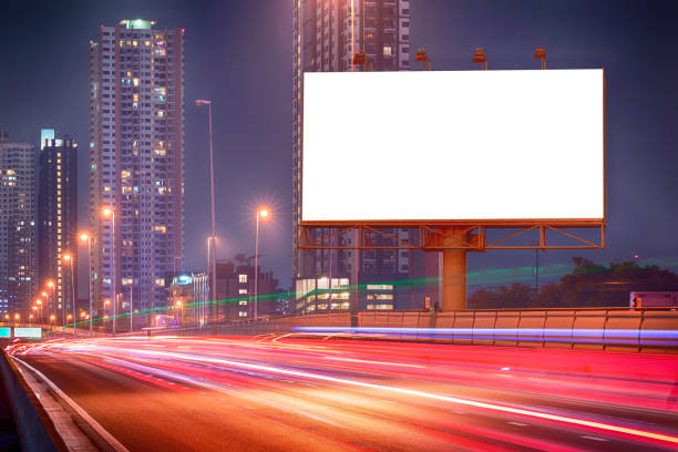 istock Blank billboard with light trails on the night street, urban 645293404