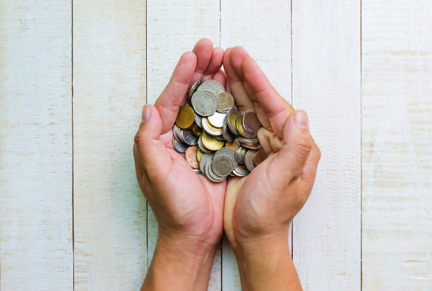 istock top view many coins in hands, investment and business concepts 645299532