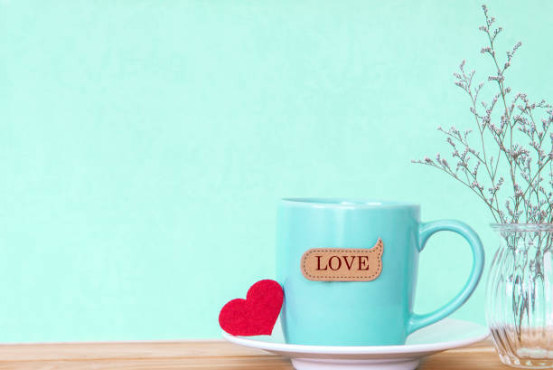 istock Coffee cup mug with red heart shapeand love word tag 645299566