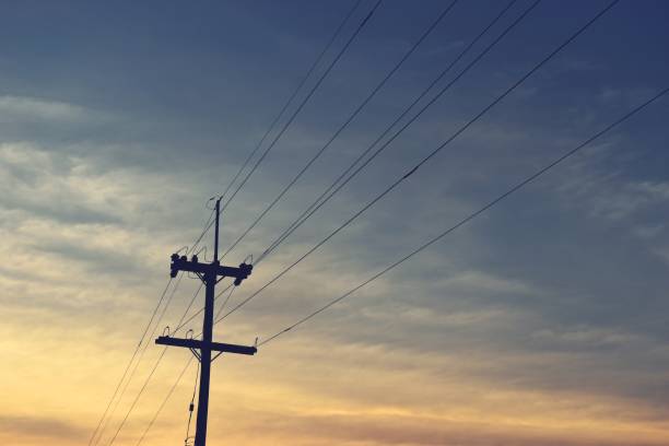 istock Electricity poles silhouette in sunset  background 645307444