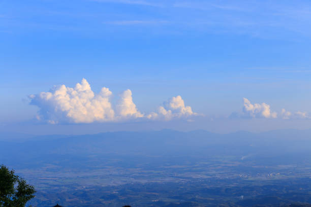 Mountain terrain city, on cloudy sky with sunlight beam. Beautiful panoramic view of highland.