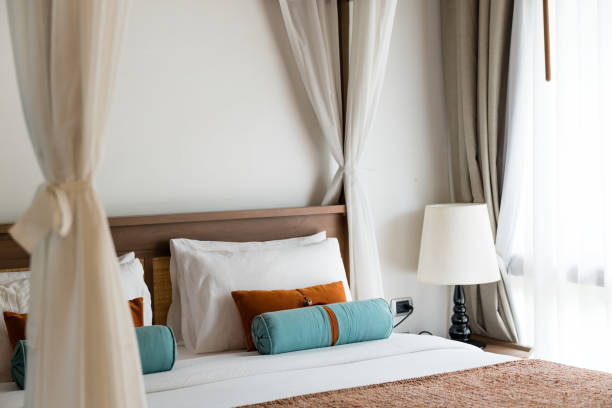 istock resort style bedroom with white sheet, brown and blue pillow 645319512