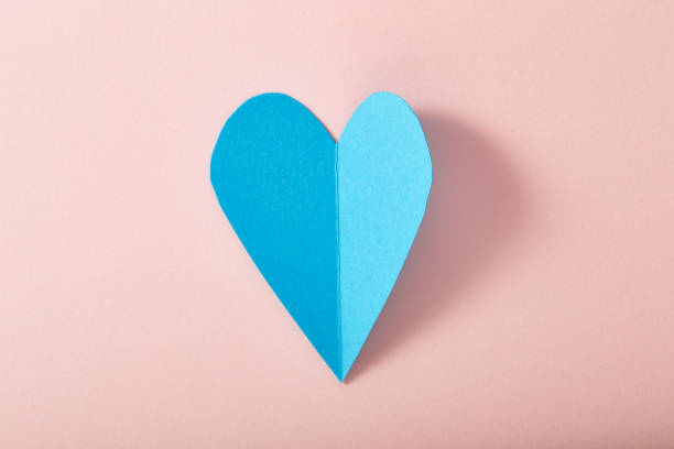 istock Blue paper heart on pink paper 645319664
