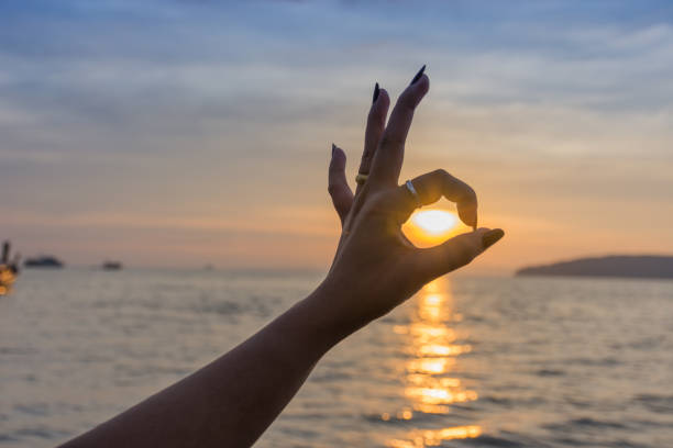 istock young woman  hand made ok The sunset 645321768