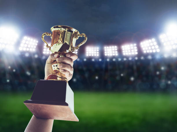 istock Man holding up a a gold trophy cup,win concept. 645324802
