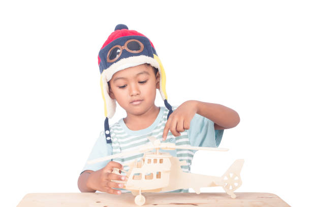 Cute asian boy play plane ,focus hand Cute asian boy play plane ,focus hand