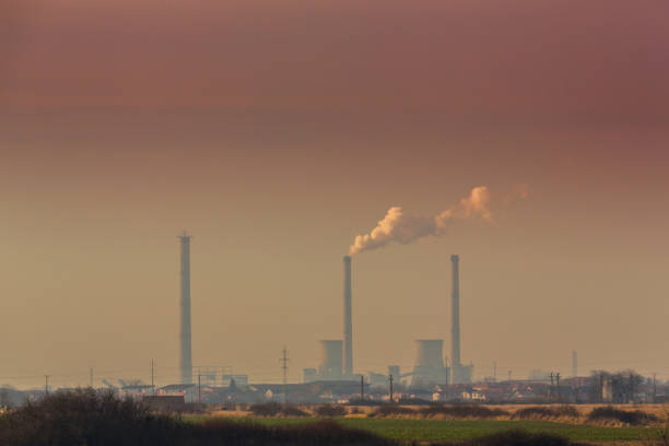 istock Air pollution from coal-powered plant smoke stacks, and industrial cityscape 645331426