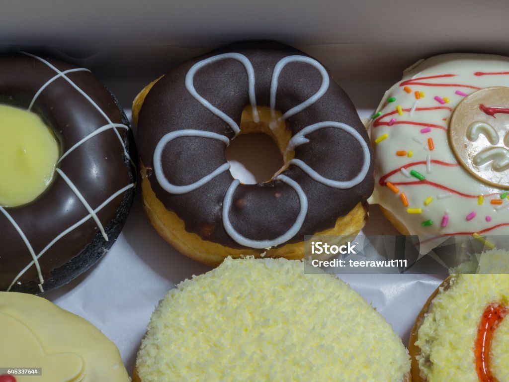 Delicious sweet donuts Photo of delicious sweet donuts toping by chocolate and cheese Baked Stock Photo