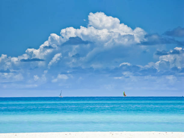 istock Two sailboat at open sea against the sky with cumulus clouds. 645340286