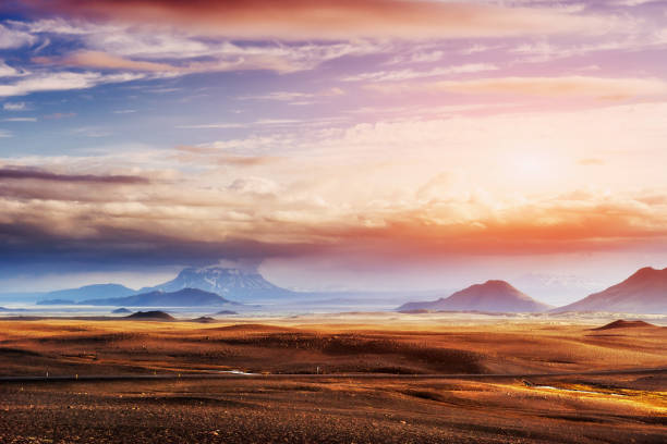 The picturesque landscapes of forests and mountains of Iceland. Nice view of the sun through cumulus clouds