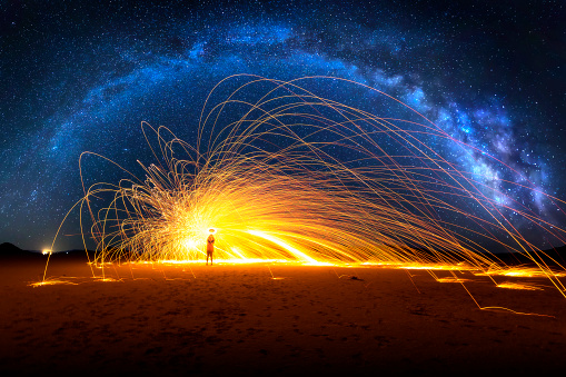 Arched Milky Way and Fiery Sparks on desert lake bed