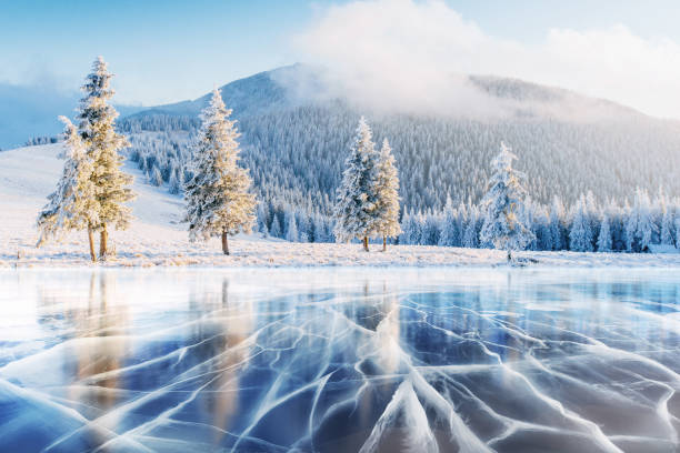 istock Blue ice and cracks on the surface of the . 645351062