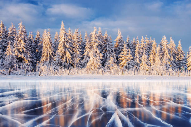 istock Blue ice and cracks on the surface of the . 645351570