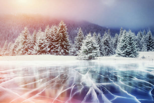 istock Blue ice and cracks on the surface of the . 645353124
