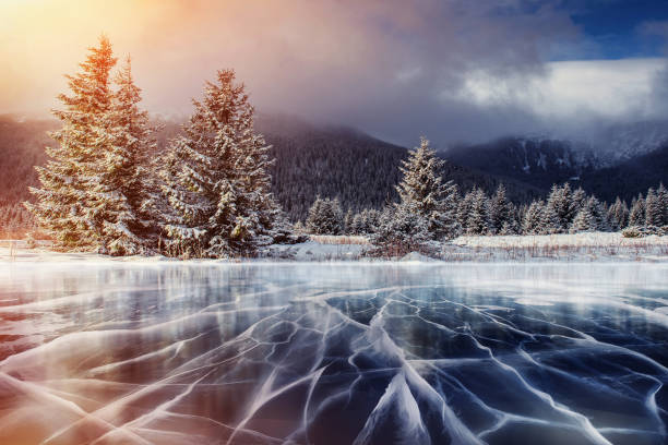 istock Blue ice and cracks on the surface of the . 645353152