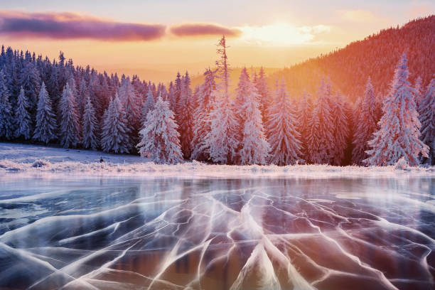 istock Blue ice and cracks on the surface of the . 645353196