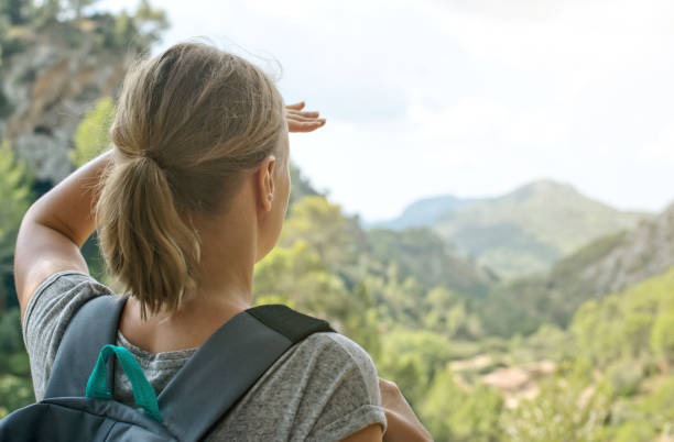 istock Woman with backpack enjoying view in mountains. 645353896