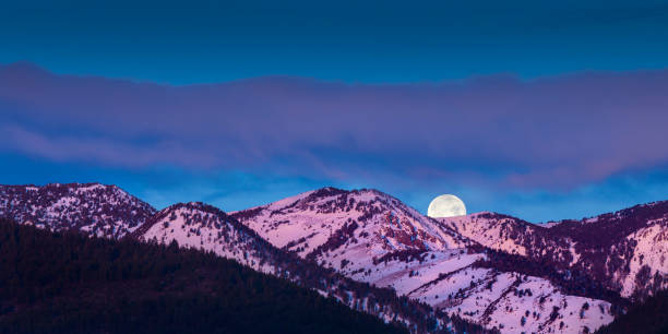 istock Moon rise over mountains with alpen glow pink light 645356722