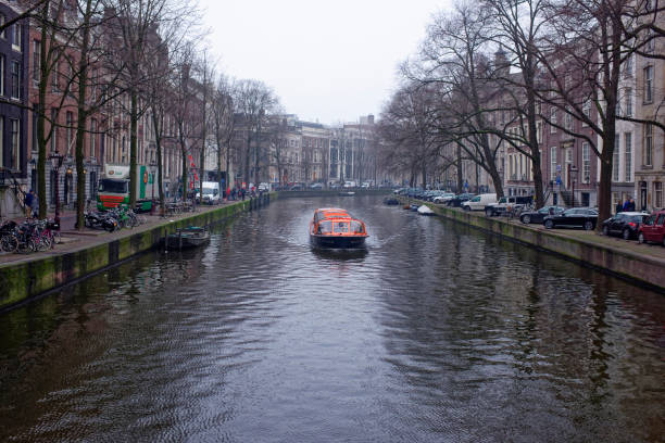 Along the canal walk citizens and moving vehicles