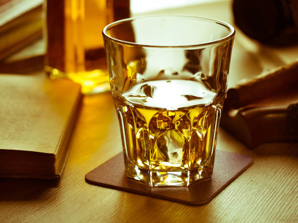 istock Whiskey on the rocks and scholar books 645360168