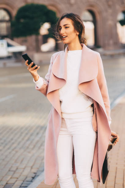 istock Beautiful elegant woman texting outdoors 645363372