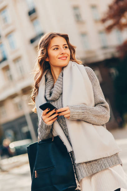 istock Young woman texting outdoors 645363384