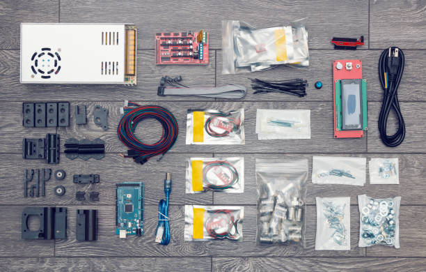 Flat lay of electronic and mechanical parts and components of DIY device on wooden surface