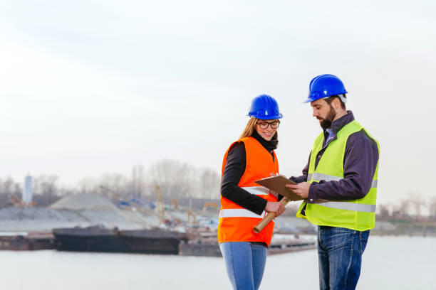 istock Teamwork in freight transportation industry - two engineers working together at the dock 645371418